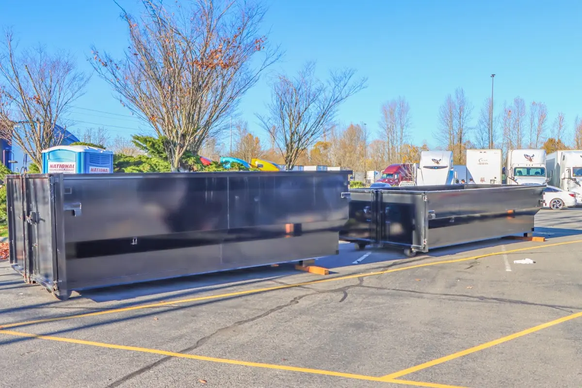 Professional dumpster rental service with roll-off container on residential driveway in Montevallo